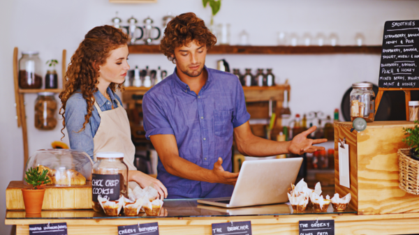 Small business owner reviewing website analytics and identifying common website mistakes.