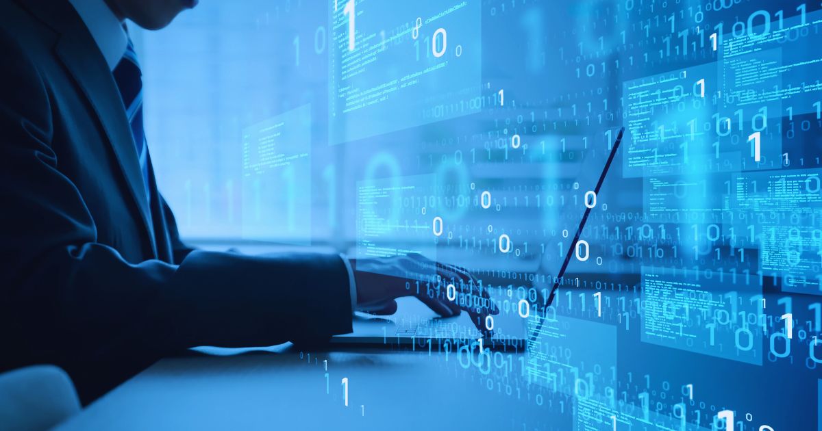 A person sits at a laptop computer and overlaid on the image are digital graphics